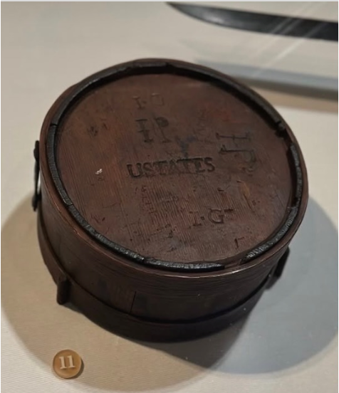 A rare wooden Continental Army soldier's canteen from the 1770s marked 'USTATES', held at the Museum of the American Revolution.